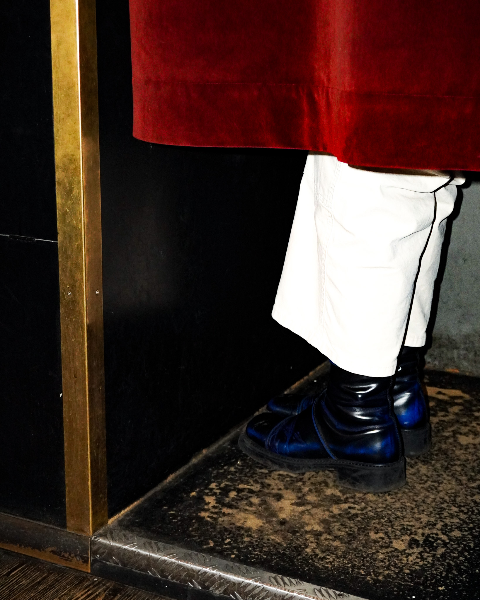 photograph of someone's legs and feet inside a photobooth